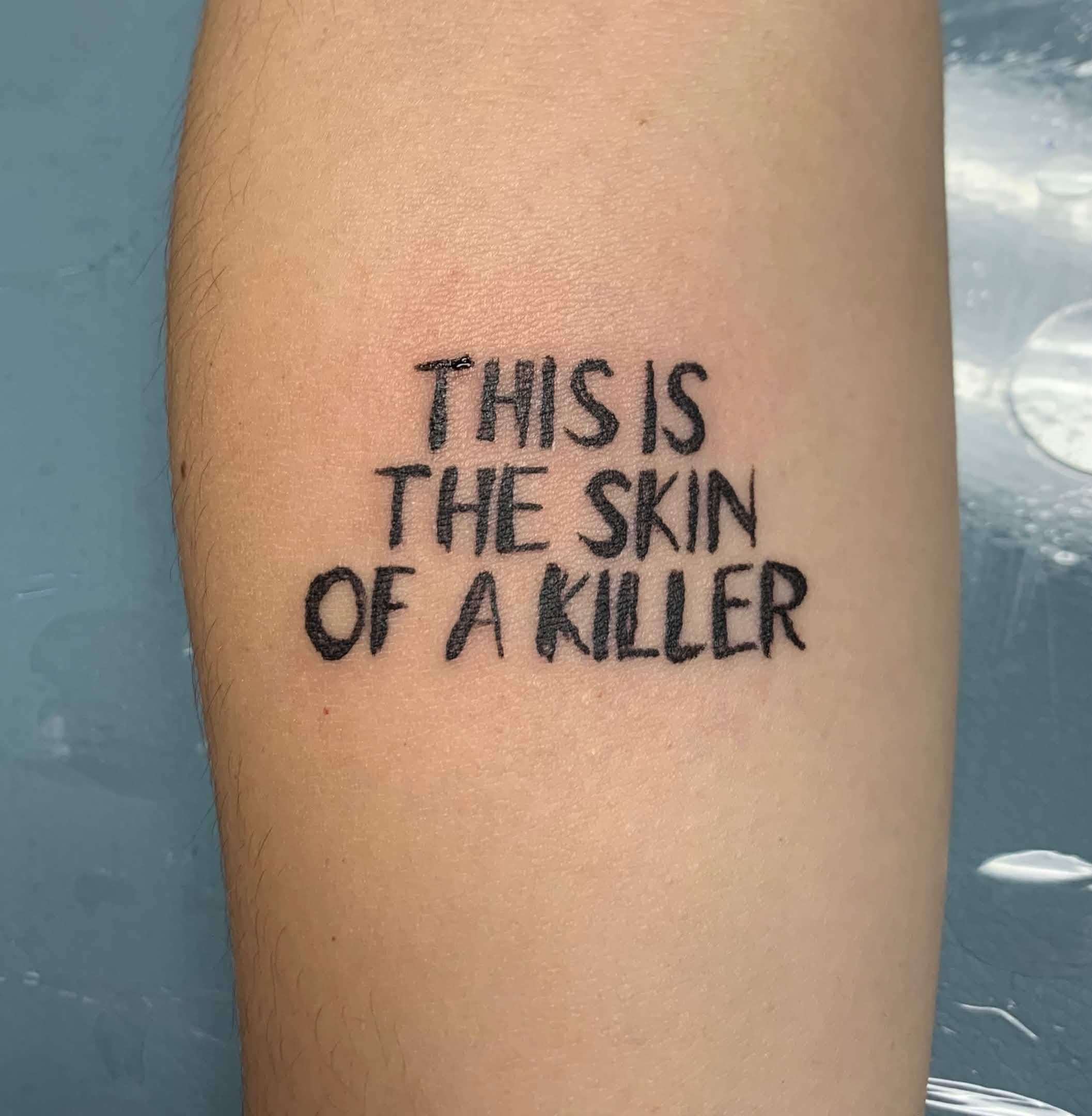tattoo that reads 'this is the skin of a killer'